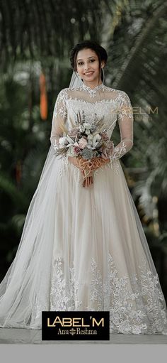 a woman in a wedding dress posing for the camera with her hands on her hips