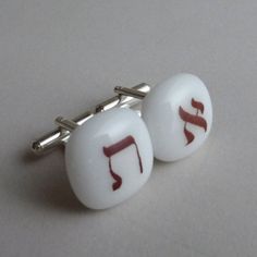 "Handcrafted to your specifications.  Upon ordering, tell us the letters you wish to have on the cufflinks - same letter or different letters on each cufflink - and we will make them for you. Fired onto the glass at 1400 F, the sepia letters are fused permanently onto the glass. We used white color art glass as a base and the fused glass top part of the cufflinks is 5/8\" x 5/8\" Best quality available metal hardware -Silver plated or sterling silver. picture #1 - set of cufflinks picture #2 - w Modern Round Cufflinks As Gift, Modern Cufflinks As Gift, Adjustable Cufflinks As Gift, Adjustable Polished Finish Cufflinks For Gift, Modern White Cufflinks For Gift, White Round Cufflinks For Gift, Modern White Cufflinks As Gift, Personalized White Jewelry For Formal Occasions, Personalized White Formal Jewelry