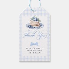 a blue and white gingham thank tag with a cake on the plate, it says