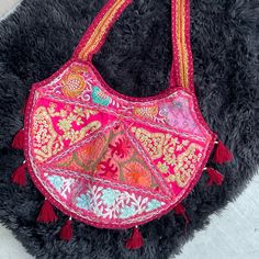 Item Embroidered Heart Shaped Shoulder Festival Ethic Bag. Features Colorful Metallic Threading In Embroidery Colors Include Red Green Purple Gold Pink Orange And Teal On Muted Red Or Pinkish Red. Gray Clean Unused Cotton Lining Full Top Zipper Closure Tassels Trim The Baseline Lightweight Folds Travel Friendly Double Straps How & Where Festival Beach Bag Vacation Travel Beach Summer Costume Size & Measurements Strap 1.5” X 29” Bag 17” X 14” Condition Like New, Flawless We Love Offers! Tags Trav Pink Shoulder Bag For Festival, Traditional Pink Tote Bag, Traditional Pink Bags For Daily Use, Pink Bohemian Embroidered Shoulder Bag, Pink Embroidered Bohemian Shoulder Bag, Festive Pink Embroidered Shoulder Bag, Bohemian Pink Embroidered Shoulder Bag, Traditional Embroidered Pink Shoulder Bag, Traditional Pink Embroidered Shoulder Bag