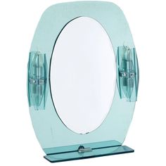 an oval shaped mirror on a stand with two mirrors attached to the back of it