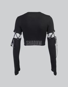 Type: Crop top Design: Gothic, techwear Ultra-resistant crop top: Designed with the best materials for a comfortable wear. Breathable materials: This crop top is made of polyester, spandex and nylon. Suitable for women Machine washable: 30 °C (86 °F) Long Sleeve Gothic Crop Top Embrace the core essence of techwear and darkwear with our alluring Long Sleeve Gothic Crop Top. Designed to be the epitome of edgy street style. The obsidian shades of the Long Sleeve Gothic Crop Top beckon the enigmatic hearts seeking to intertwine the modern urban style with the timelessly mystic Gothic aesthetic. The dark canvas of the crop top perfectly contrasts with the logo on the bust, embodying a blend of minimalism and boldness. Adorning a hood that serves as a veil to the unseen, the Gothic Crop Top adds Fitted Black Techwear Top, Fitted Futuristic Black Top, Futuristic Fitted Black Top, Fitted Techwear Tops For Workout, Black Rave Crop Top For Streetwear, Black Stretch Rave Crop Top, Black Stretch Crop Top For Rave, Alternative Style Fitted Black Crop Top, Alternative Fitted Black Crop Top