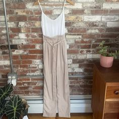 And Merci Beige And White Tie Waist Sleeveless Jumper Size S Nwt This And Merci Jumpsuit In Beige And White Is A Stylish Piece That Will Make You Stand Out In Any Occasion. It Features A Tie Waist Closure That Accentuates Your Curves And Creates A Flattering Silhouette. The Sleeveless Design And Wide-Leg Style Make It Perfect For Summer, Fall, And Spring Seasons. Made Of High-Quality Polyester, This Jumpsuit Is Comfortable To Wear And Easy To Care For. The Solid Pattern, Casual And Workwear Occa Fitted High-waisted Jumpsuits And Rompers For Summer, Fitted High-waisted Summer Jumpsuits And Rompers, Casual Sleeveless Cream Jumpsuits And Rompers, Beige Jumpsuits And Rompers For Summer Daywear, Cream Sleeveless Jumpsuit For Day Out, Sleeveless Cream Jumpsuit For Day Out, Beige Jumpsuits And Rompers For Spring Daywear, High-waisted Jumpsuits And Rompers For Summer Day Out, White High-waist Jumpsuits And Rompers For Summer