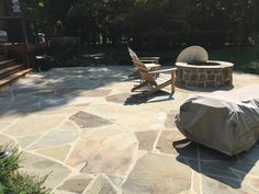 an outdoor patio with chairs and fire pit