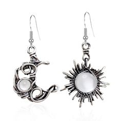 pair of silver tone earrings with white stone in the shape of a sun and moon