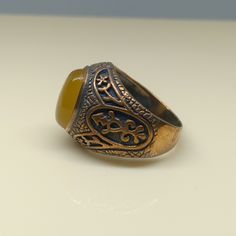 This empower ring is an awesome design bronze ring with an oval yellow Aqeeq. It is an awesome Masonic icon design bronze ring with a cabochon Yellow Aqeeq. It is an awesome design bronze ring. It has designed and made in Thailand. It is for the people who love to collect rare limited edition items and who wants to be different. This ring is one of a kind item for you. Material: Bronze The Main Stone: Yellow Aqeeq (Yellow Agate) Stone Color: Yellow Stone size: 10 x 14 mm. Ring weight approx.: 8 Handmade Brown Signet Ring As Gift, Handmade Brown Signet Ring For Gift, Vintage Bronze Signet Ring Gift, Vintage Bronze Signet Ring For Gift, Vintage Brown Signet Ring As A Gift, Antique Brown Cabochon Ring, Bronze Oval Rings As Gifts, Bronze Oval Rings For Gift, Oval Bronze Rings For Gift