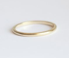 a plain gold wedding ring on a white background with space for your text or image