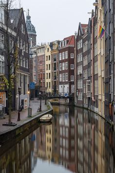 a river running through a city next to tall buildings