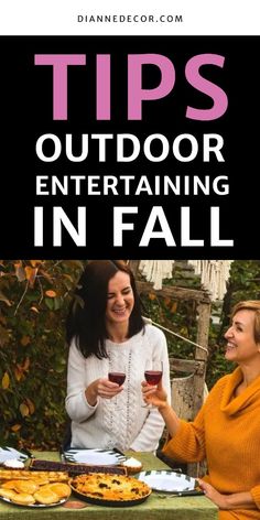 two women toasting wine at an outdoor table with pies on it