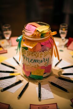 a jar filled with lots of notes on top of a table