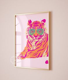 a pink and yellow tiger with sunglasses on it's face is mounted to the wall