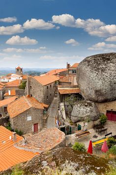 an aerial view of some buildings and a large rock