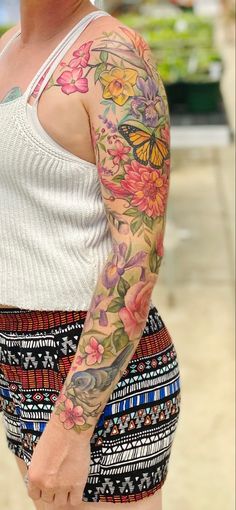 a woman with a butterfly tattoo on her arm