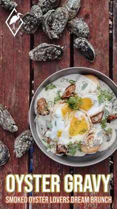 a bowl filled with food sitting on top of a wooden table next to oysters