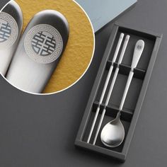 two spoons, fork and knife in a box