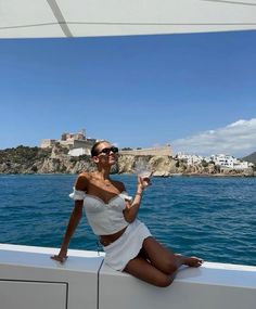 a woman sitting on the back of a boat