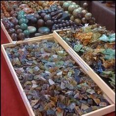 two boxes filled with different types of glass pebbles