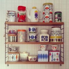 a shelf filled with lots of cups and mugs