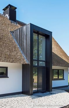 an image of a house with thatched roof and glass doors on the front door