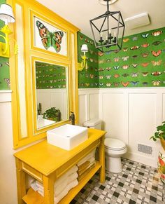 a bathroom with green and yellow wall paper