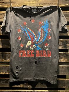 Country Deep Free Bird 22 vintage distressed 1980's unisex T shirt available in faded black 40 Singles Jersey 100% Cotton Premium quality ringspun and compacted cotton Fine Cotton Jersey that is pigment dyed for a more vintage look Features tears and destroyed features at neck and on body Each piece is unique as this process is done by hand! 3.8 oz Made In USA Every garment dye item can be a slightly different shade in color since this is a laundry dye process. Enjoy its unique quality! SIZE CHA Edgy Faded Distressed T-shirt, Stonewashed Band Merch T-shirt With Crew Neck, Band Merch Stonewashed Crew Neck T-shirt, Stonewashed Cotton Band Merch T-shirt, Punk Washed T-shirt For Streetwear, Punk Style Washed T-shirt For Streetwear, Retro Stonewashed Short Sleeve T-shirt, Vintage Stonewashed Short Sleeve T-shirt, Edgy Stonewashed T-shirt In Washed Black