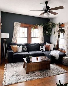 a living room filled with furniture and a ceiling fan in the middle of the room