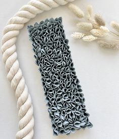 a white rope and some gray objects on a table