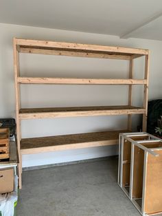 a room with some shelves and boxes on the floor