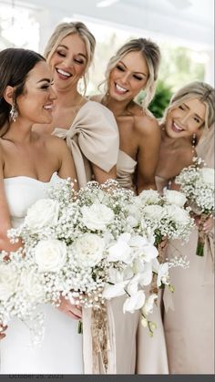 the bridesmaids are holding their bouquets together