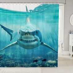 a shower curtain with a shark swimming in the ocean and fish around it's neck