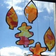 an image of stained glass hanging from the ceiling in front of a blue sky with clouds