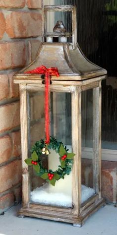 an old lantern with a wreath on it