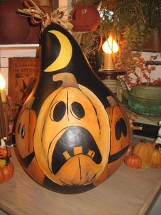 a large pumpkin shaped like a face on top of a table