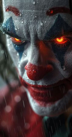 a close up of a clown's face with red eyes and white makeup in the rain