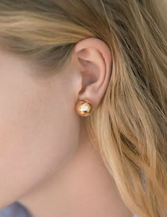 hollow 14k yellow gold sphere stud earring. each sphere sold individually. available in 3 sizes. 12mm stud pictured on model. made in los angeles. kathleen whitaker Kathleen Whitaker, Floating Earrings, Gold Sphere, Cascade Necklace, Hammered Hoop Earrings, Ear Clips, Gold Stud Earrings, Affordable Jewelry, Gold Stud