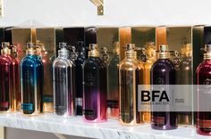 many different types of perfume bottles on a shelf