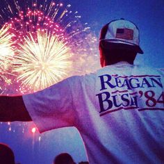 a baseball player is watching fireworks go off in the sky