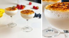 two glasses filled with drinks sitting on top of a table next to bananas and strawberries