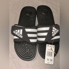 Nwt Black And White Adidas Sandals, Size 11, In Men/12 In Women Adidas Black Synthetic Flip Flops, Adidas Black Synthetic Sport Sandals, Adidas Non-slip Open Toe Flip Flops, Casual Black Adidas Flip Flops, Comfortable Black Adidas Sandals, Adidas Cushioned Round Toe Flip Flops, Adidas Sandals, Black And White Adidas, Yeezy Slides