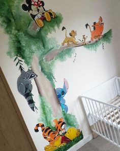 a baby's room with winnie the pooh mural