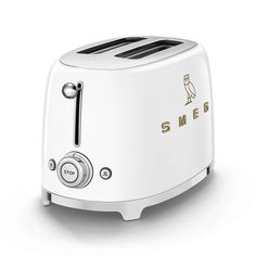 a white toaster with an owl on the side and smeg logo in gold