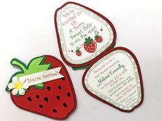 three strawberry shaped magnets with words on them