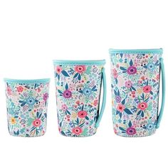 three flowered cups with handles on each one and the other two are blue, pink,