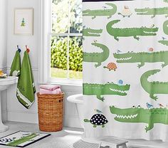 a bathroom with a green and white shower curtain