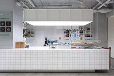 the inside of a store with white tiled walls