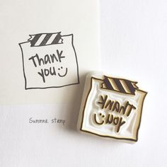 a rubber stamp with the words thank you written on it next to a piece of paper