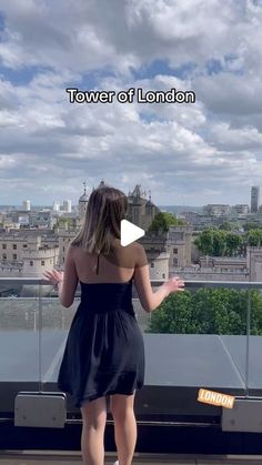 a woman standing on top of a roof looking at the city below with text that reads tower of london