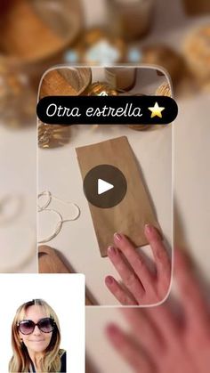 a woman's hand holding a brown paper bag with the words otra estrella on it