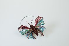 "Brown turquoise butterfly brooch pin, insect art sculpture jewelry handmade of colored copper and silver wire.  Wire bug brooch, unusual gifts for women. *Dimensions *Height: 4.5cm (1.77in). *Width: 6cm (2.36in).  * The pin is handmade solid silver. For more butterfly pins take a look here https://www.etsy.com/shop/VassilikiMikropoulou?ref=seller-platform-mcnav&sort_order=date_desc&search_query=butterfly+pin My \"micro sculpture\", wire contemporary jewelry, evolved from many years of designing Unique Butterfly Brooches For Gifts, Unique Handmade Turquoise Brooches, Unique Handmade Turquoise Brooch, Handmade Turquoise Brooches As Gift, Handmade Turquoise Brooches For Gift, Micro Sculpture, Unusual Gifts For Women, Sculpture Wire, Sculpture Jewelry