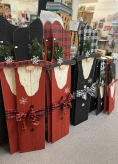 several wooden sleighs with christmas decorations on them are displayed in a store